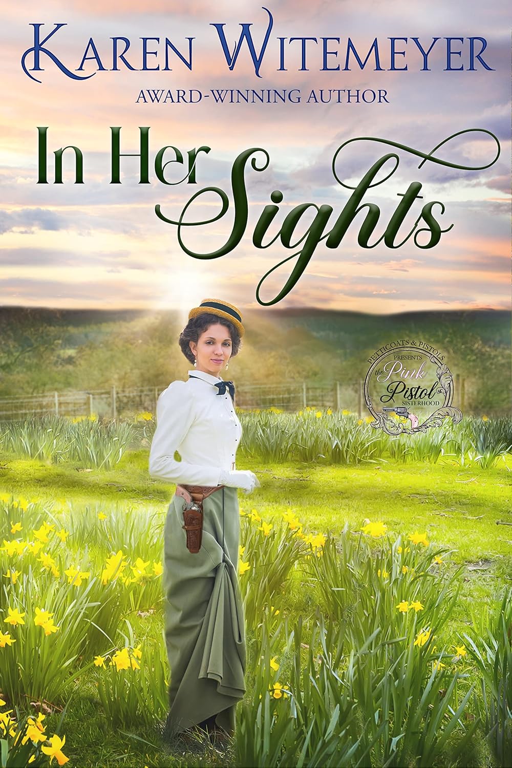 In Her Sights Book cover for "In Her Sights" by Karen Witemeyer. A woman with dark hair in a straw boater hat, white blouse, and green skirt stands in a vibrant field of yellow daffodils. She wears a leather holster with a pistol at her hip against a soft sunset sky. Includes the "Pink Pistol Sisterhood" logo.